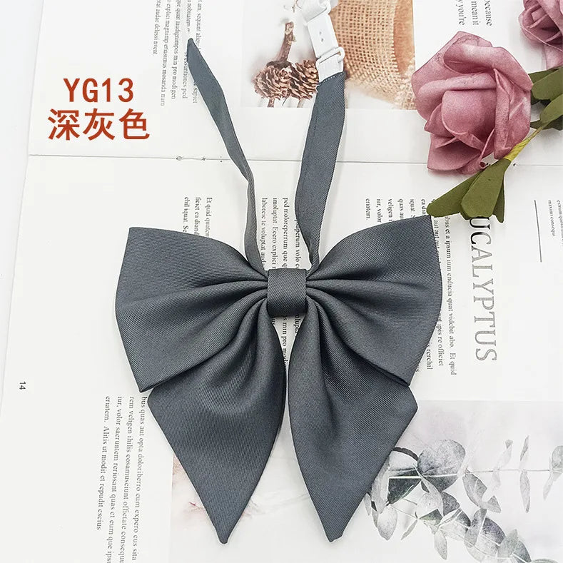 A dark gray solid cotton bow tie tied in a bow shape shown on a white background.