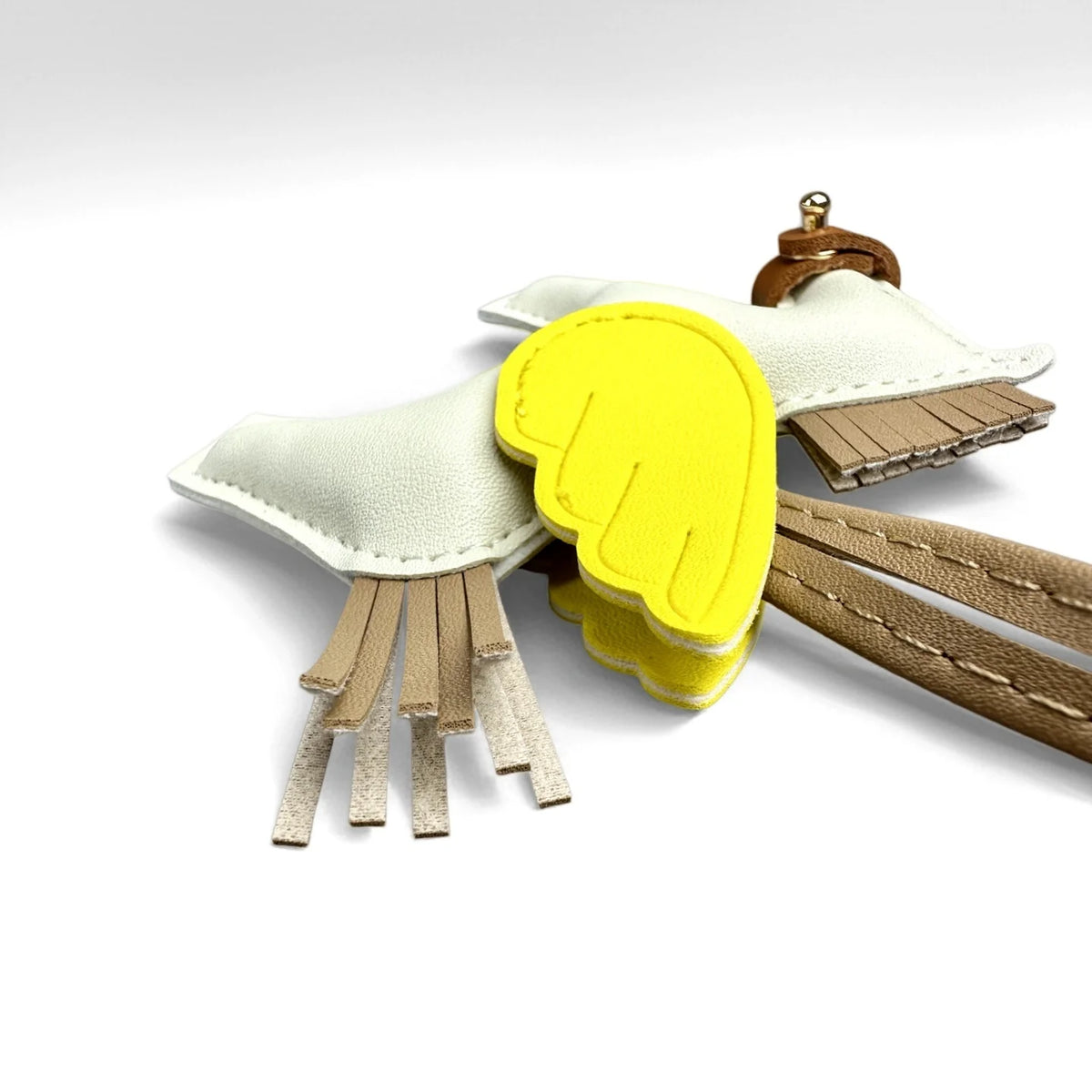 A yellow and white elegant winged pony keychain featuring a stylized wing design.