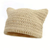 A beige crocheted beanie hat with cat ear style ears.