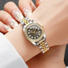 A close-up of a silver and gold rhinestone quartz wristwatch worn on a woman's wrist.