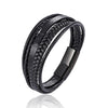 Black braided leather bracelet with a silver clasp and a compass design.
