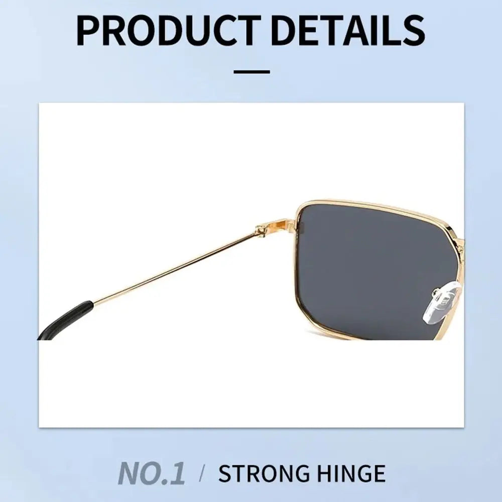 A pair of black sunglasses with a gold metal frame and a clear lens shown in a product detail photo.