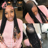 A woman modeling a 36-inch braided cornrow wig with black hair and gold accents.