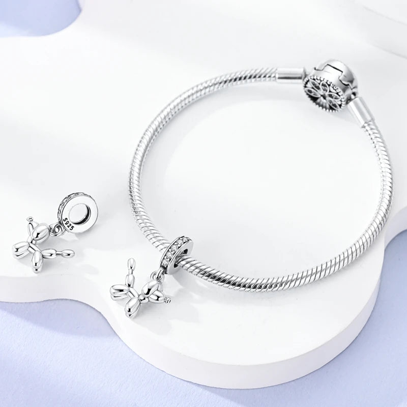 Sterling silver devil's eye charm bracelet displayed on a white surface.