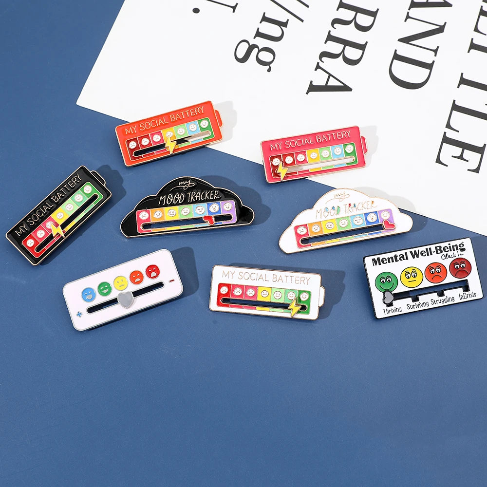 A collection of mood tracker pins and badges featuring various facial expressions and emotions on a blue background.