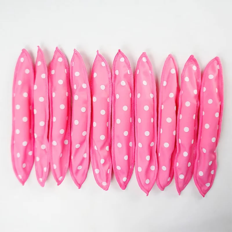A set of ten pink flexible hair curling rollers arranged in a row.