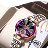 A luxurious stainless steel quartz ladies wristwatch with a pink and purple face is displayed in a light-colored box.