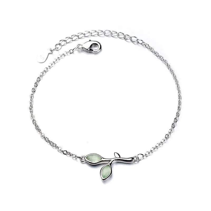 Sterling silver double heart charm bracelet with a delicate chain and two leaf charms