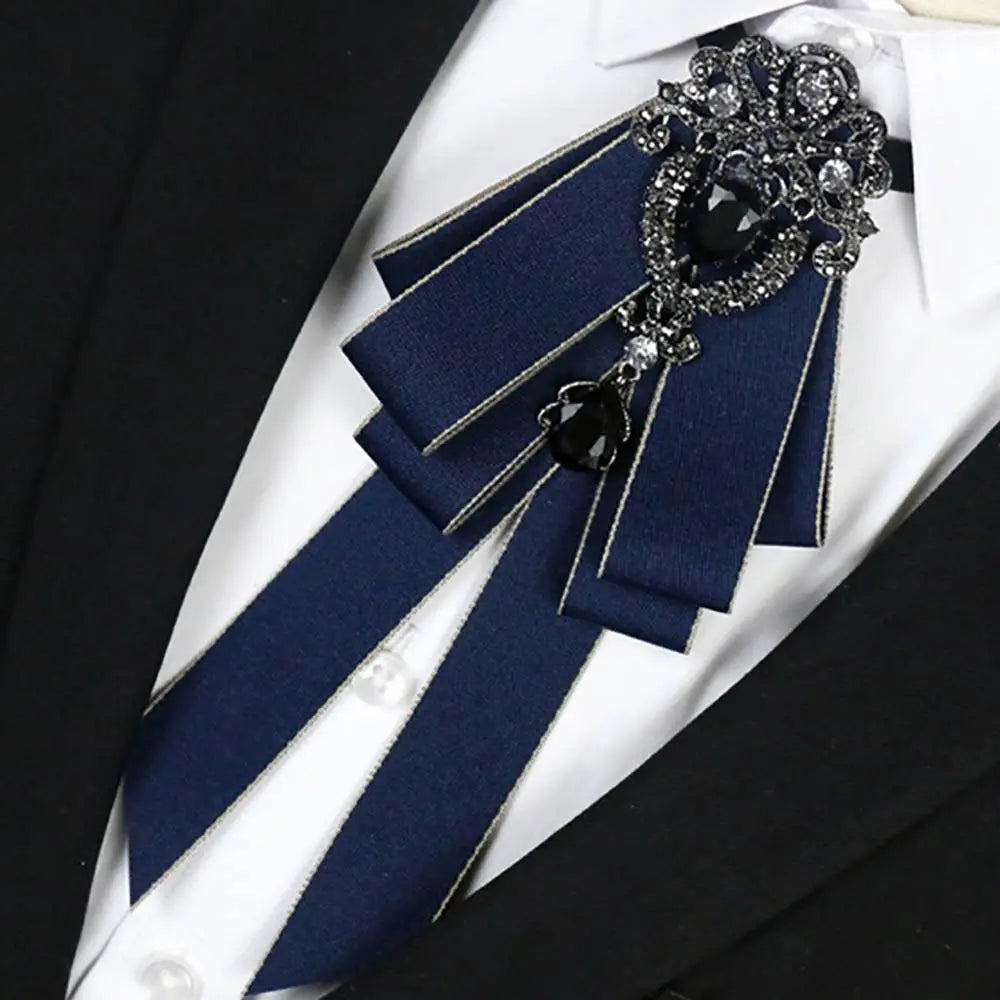 A dark blue luxury rhinestone bow tie neck tie with silver accents and a black gemstone detail.