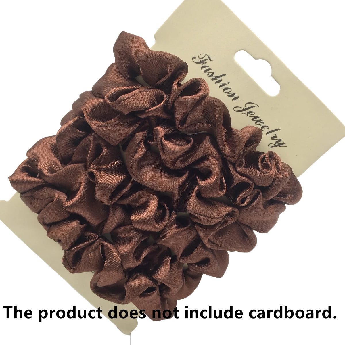 A pile of dark brown satin hair scrunchies is displayed on a light cardboard tag.