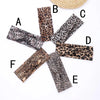 Eight leopard print fabric headbands arranged around a central point.