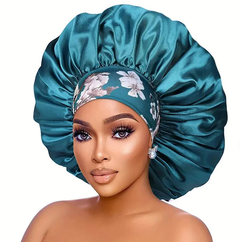 A woman wearing a teal satin sleep bonnet with an elastic band