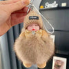 A cute cartoon plush doll with a knitted hat and fur collar is being held by a hand.