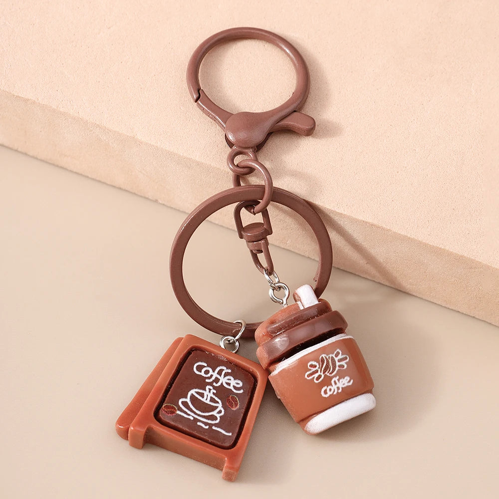 A brown leather coffee keychain featuring a cup design and a circular keyring.