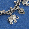 Silver charm bracelet featuring elephant and heart pendants on a chain