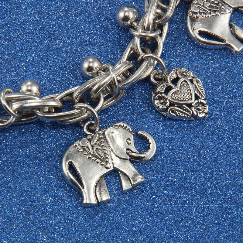 Silver charm bracelet featuring elephant and heart pendants on a chain