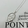 A dainty golden Christian necklace featuring a textured pendant design.