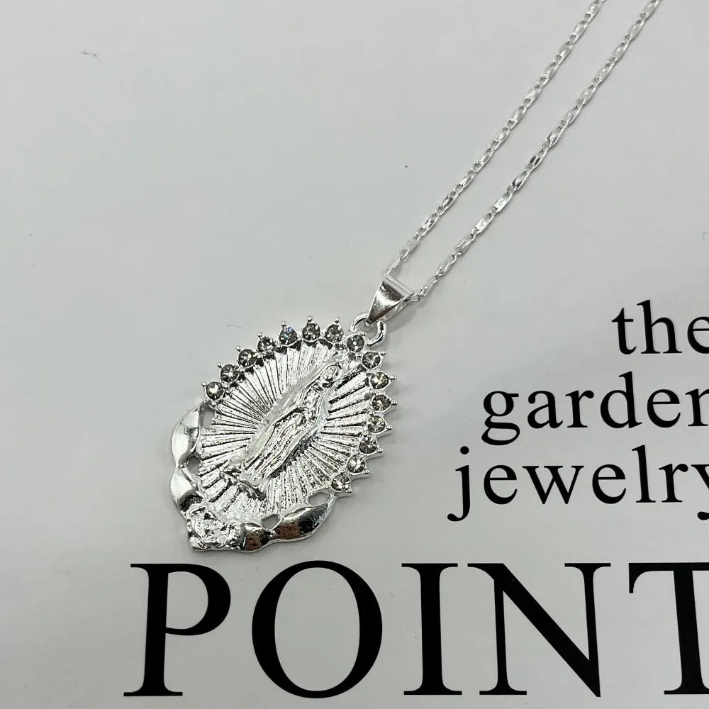 A dainty golden Christian necklace featuring a textured pendant design.