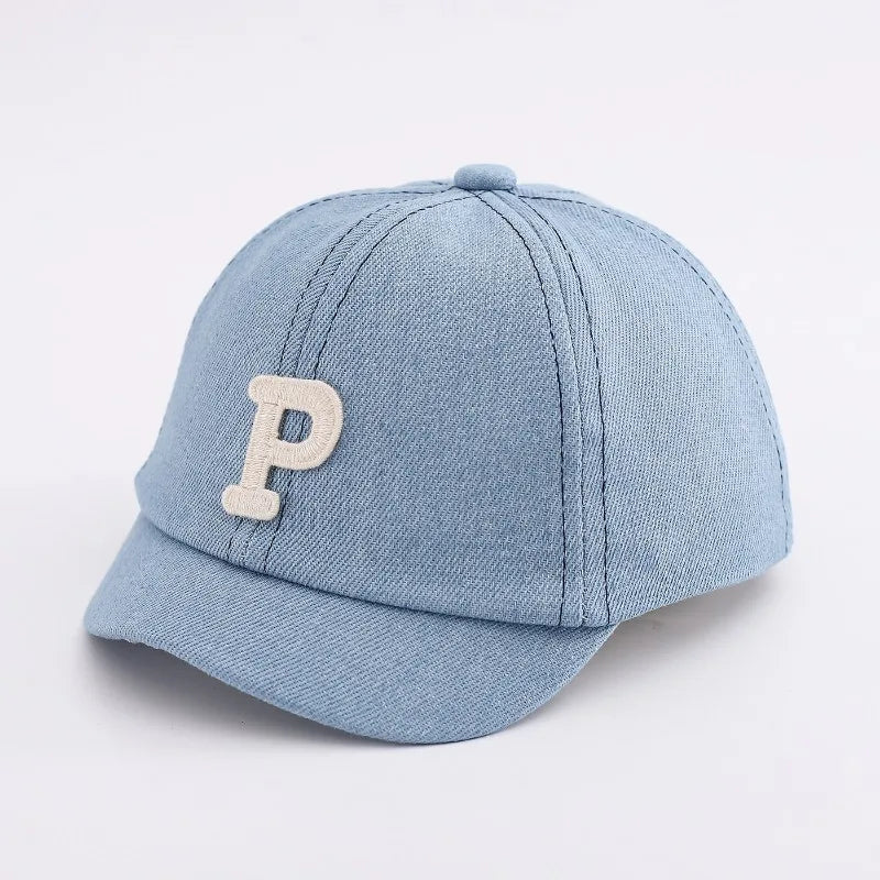 Light blue denim baseball cap with a beige letter P embroidered on the front