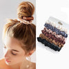 A collection of elegant simulation silk hair ties in various shades of beige, brown, and black.