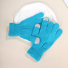 A pair of bright blue knit gloves with gray accents resting on a white plate.