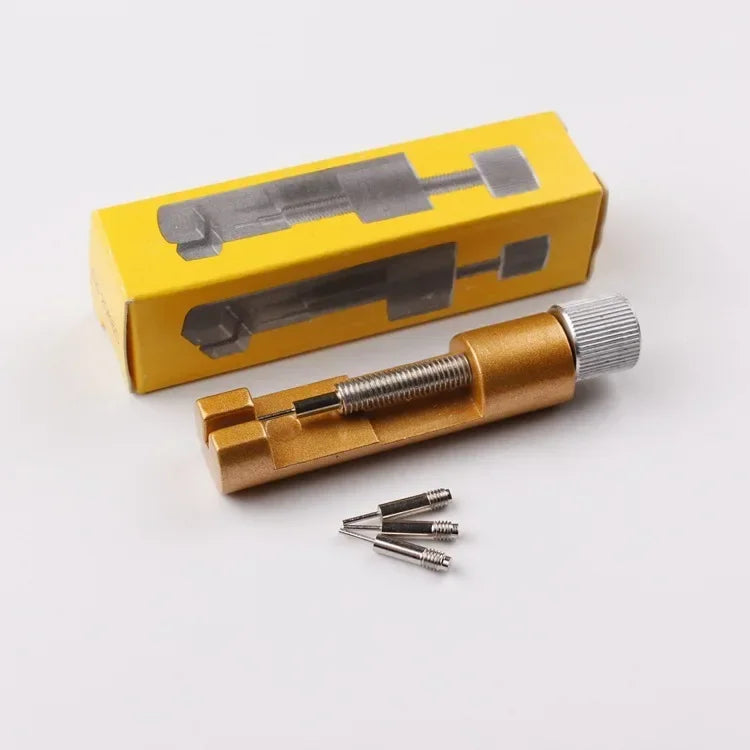 A set of three gold-colored precision watch link pin remover tools packaged in a yellow box.