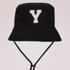 Black sun hat with a gold letter Y print and an adjustable cord