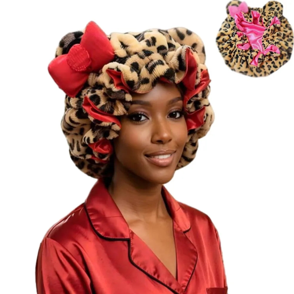 A woman wearing a leopard print hair drying cap with red floral accents and a red satin shirt.