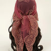 A deep maroon floral embroidered lace bandana headscarf tied around dark hair.