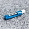 A blue precision watch link pin remover tool with a silver threaded tip resting on a gray fabric surface.