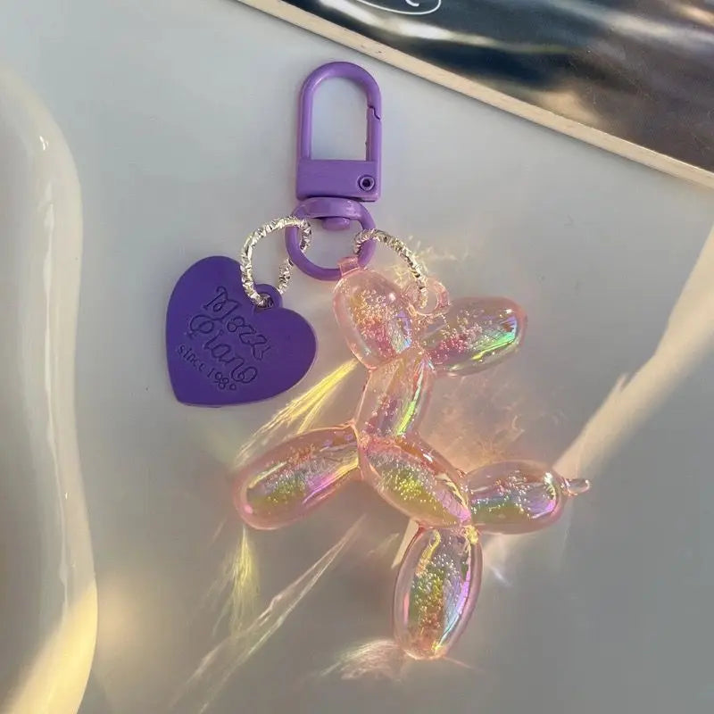 A pink, translucent jelly cartoon dog keychain with a purple clasp and a purple tag.
