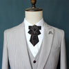 A light gray suit jacket displayed on a mannequin with a black tie featuring diamond embellishments.