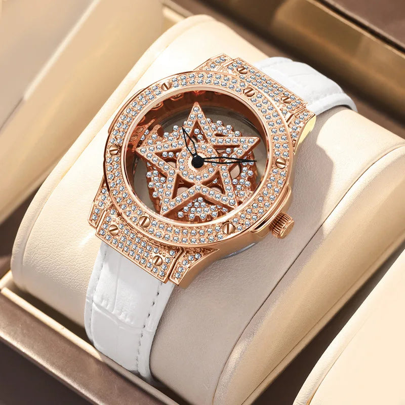 A gold-toned luxury watch with a diamond-encrusted bezel and a star motif is displayed in a light beige box.