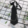 A black classic chain necktie is displayed against a grid background of various photos and greenery.