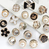 A collection of elegant button brooch pins featuring pearls, gold accents, and floral designs.