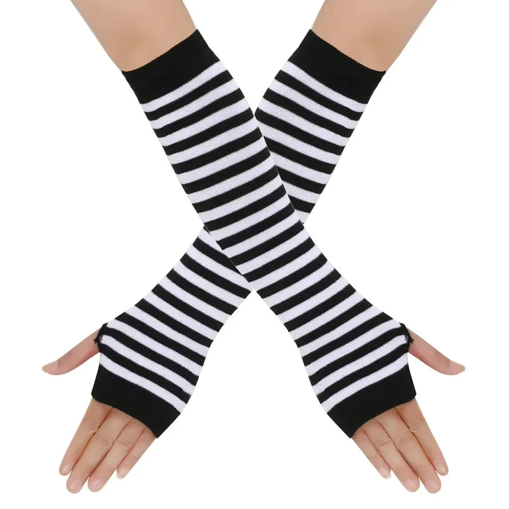 Black and white striped knitted fingerless gloves crossed on a hand