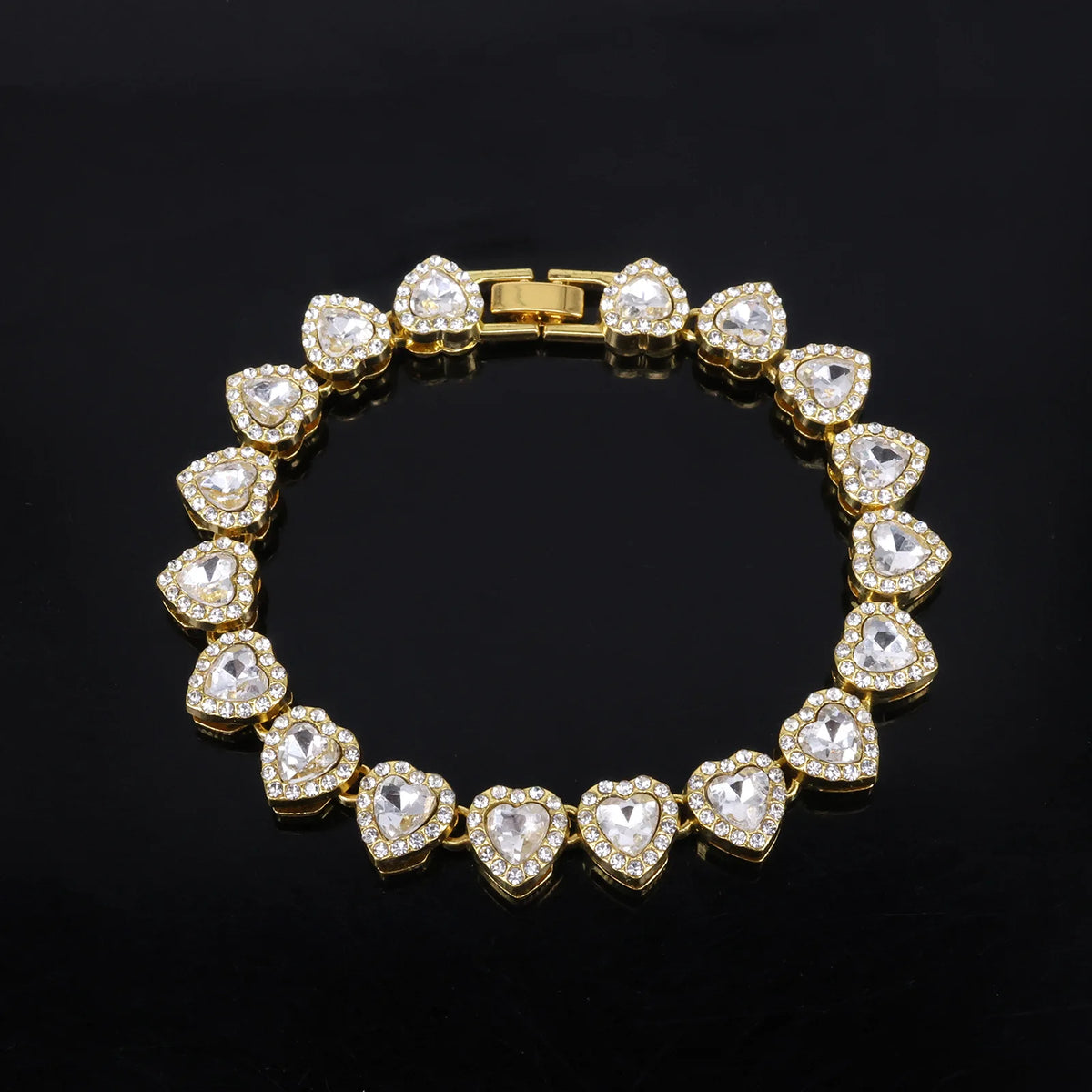 A gold-toned necklace and bracelet set adorned with sparkling heart-shaped rhinestones.
