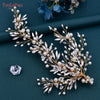 A delicate bridal headpiece featuring white pearls and clear rhinestones arranged in a floral vine design.