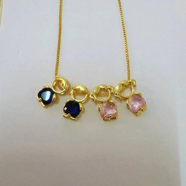 Gold heart pendant necklace featuring blue and pink gemstone accents on a gold chain
