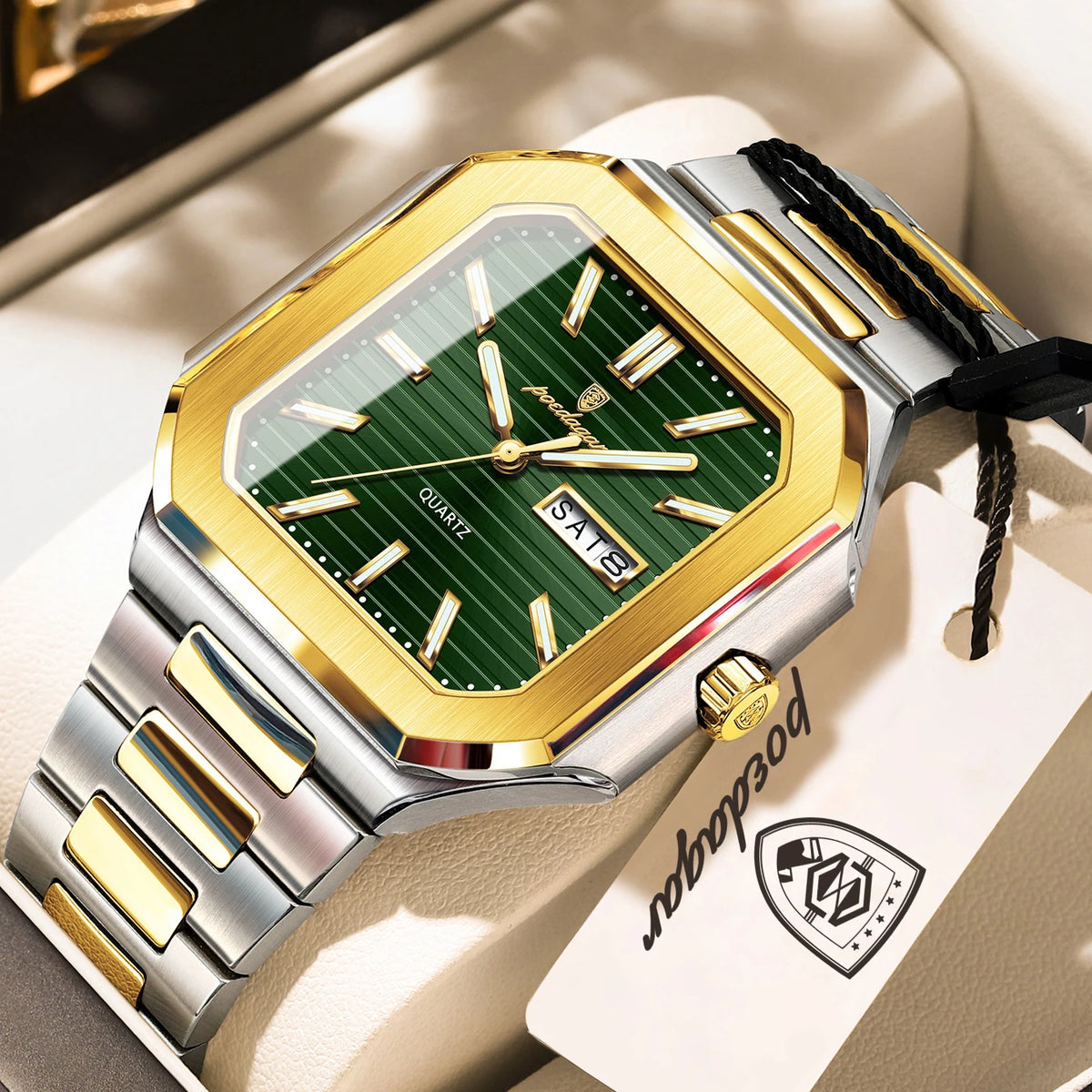 A close-up of a gold and silver stainless steel quartz watch with a green dial and black strap resting on a light-colored sur