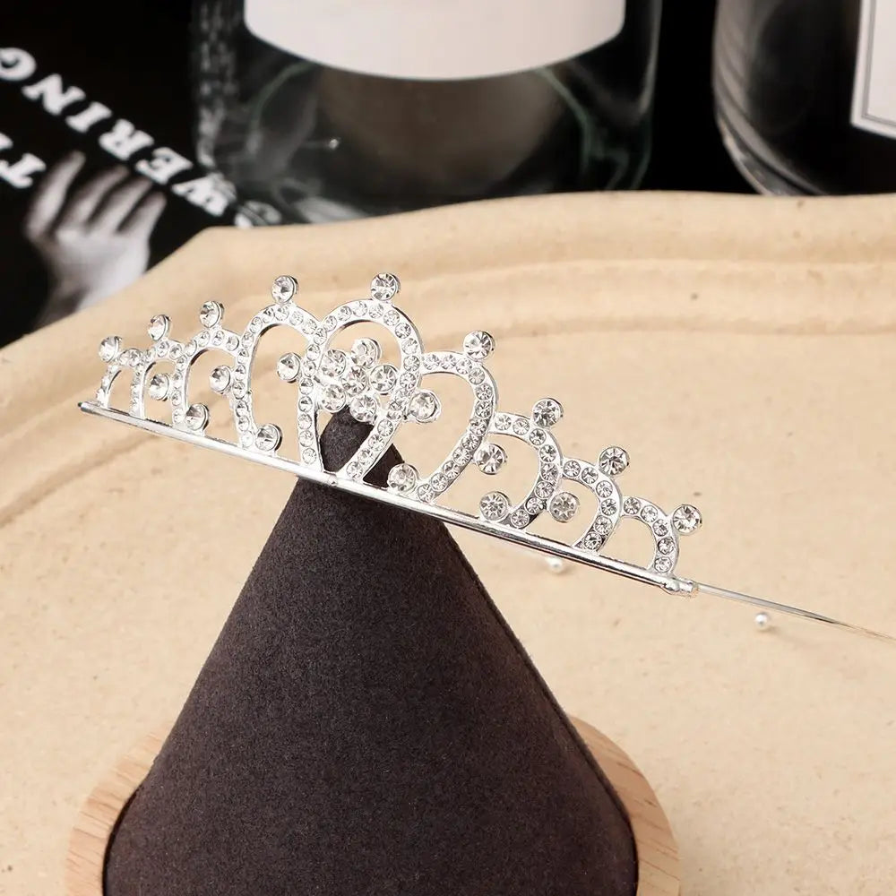 Silver crystal hair crown for women displayed on a dark fabric background