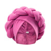 A pink, heavily braided turban cap for African party headwear.