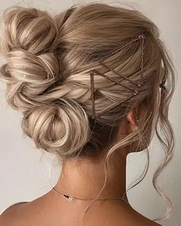 A woman's hair is styled in an elegant updo using brown hair and clear bobby pins.
