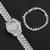 A silver rhinestone heart watch set featuring a wristwatch and a bracelet on a black background.