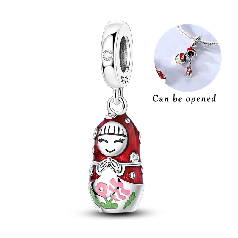 Sterling silver devil's eye charm bracelet featuring a red and white enamel charm with a green gemstone.