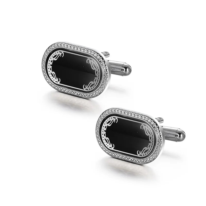 A pair of elegant silver cufflinks with black onyx and silver detailing.
