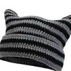 A close-up of a black and gray crocheted cat ears beanie hat.