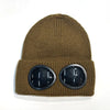 A brown knit windproof hat with a visor and round black sunglasses.