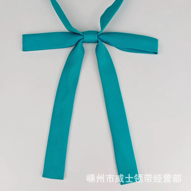 A teal fabric ribbon tied in a bow, presented as a classic butterfly ribbon tie set for students.