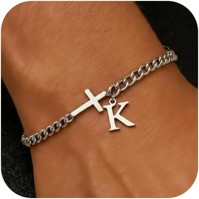 A close-up of a personalized stainless steel cross Cuban chain bracelet worn on a wrist.